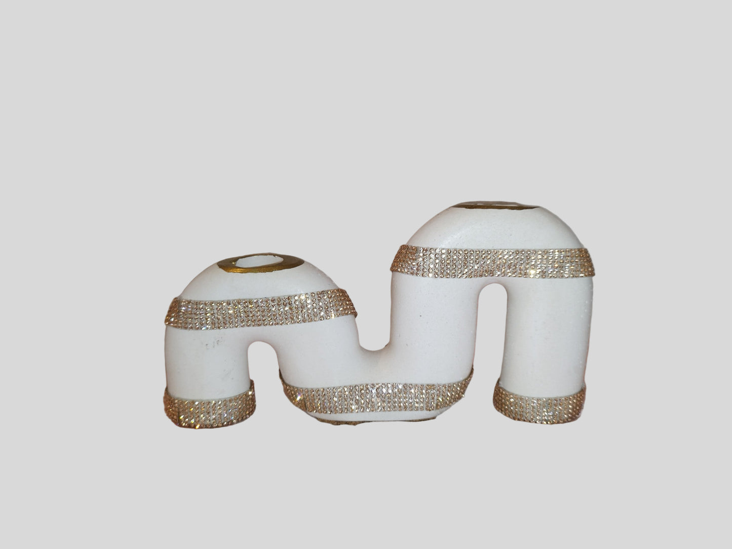 Decorative candle holder with gold glitter on a white background
