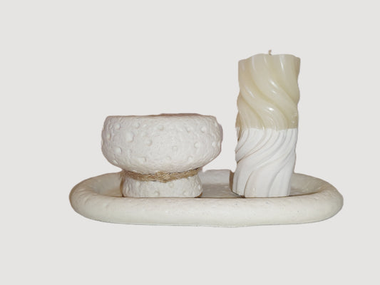 Decorative candle holder with a textured candle on a plain background