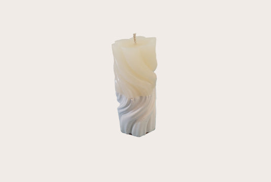 Decorative candle with a cement base on a white background