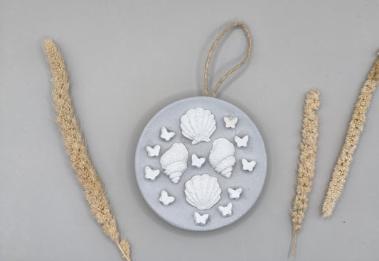 Στρογγυλό διακοσμητικό τοίχου με τσιμεντένια κοχύλια