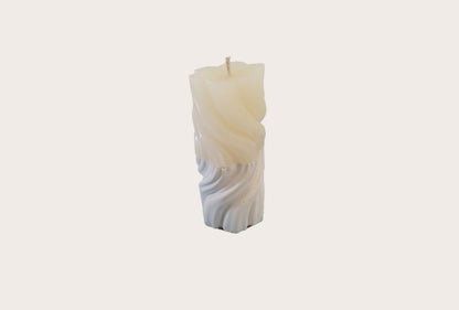 Decorative candle with a cement base on a white background
